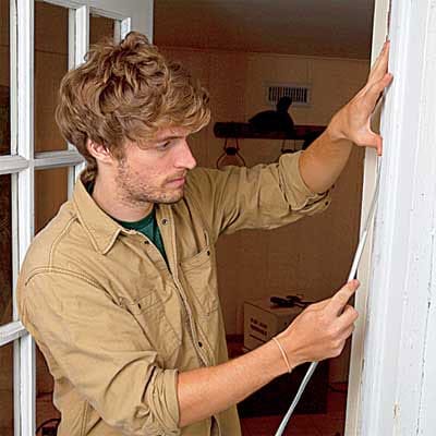 weatherstripping a door to a basement and garage