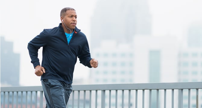 Middled aged man running through city