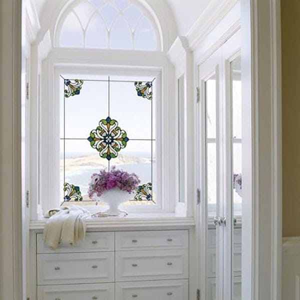 A window decorated with colorful appliqués.
