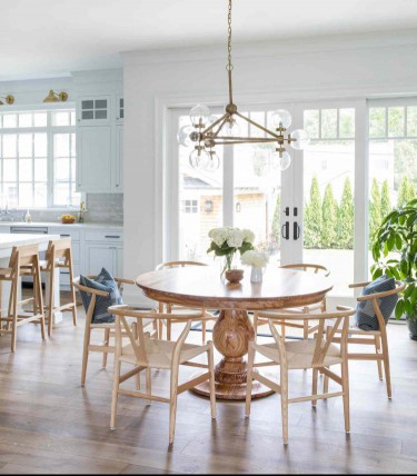 Rustic wood farmhouse pedestal dining table table with wishbone dining chairs 