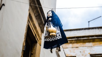 a witch doll hanging from a clothes-line holiday traditions