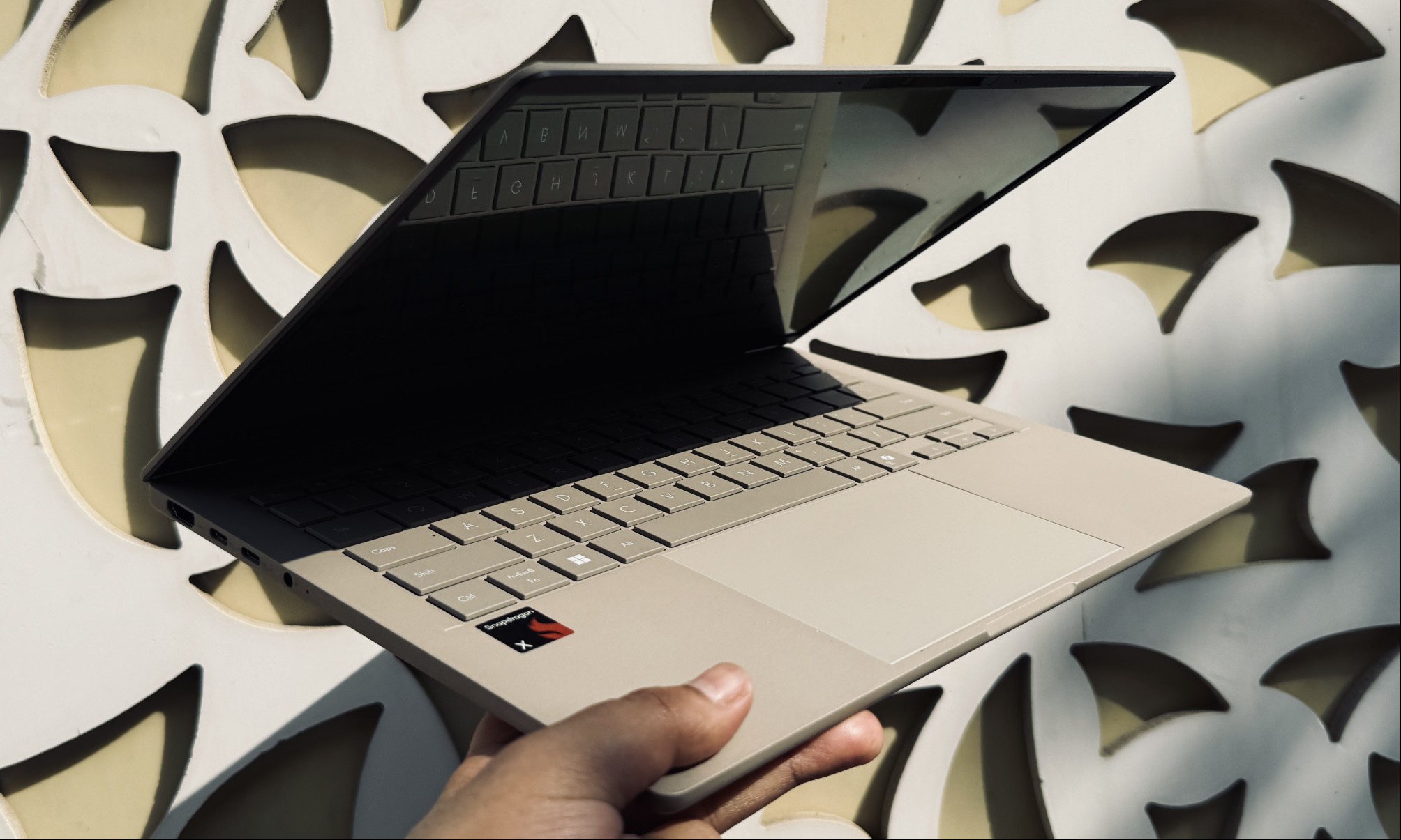 Person holding the Asus ZenBook A14 laptop.