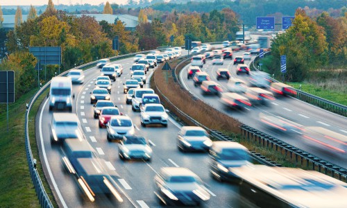 German autobahn with lots of cars speeding by, a representation of the German stereotype around love of cars