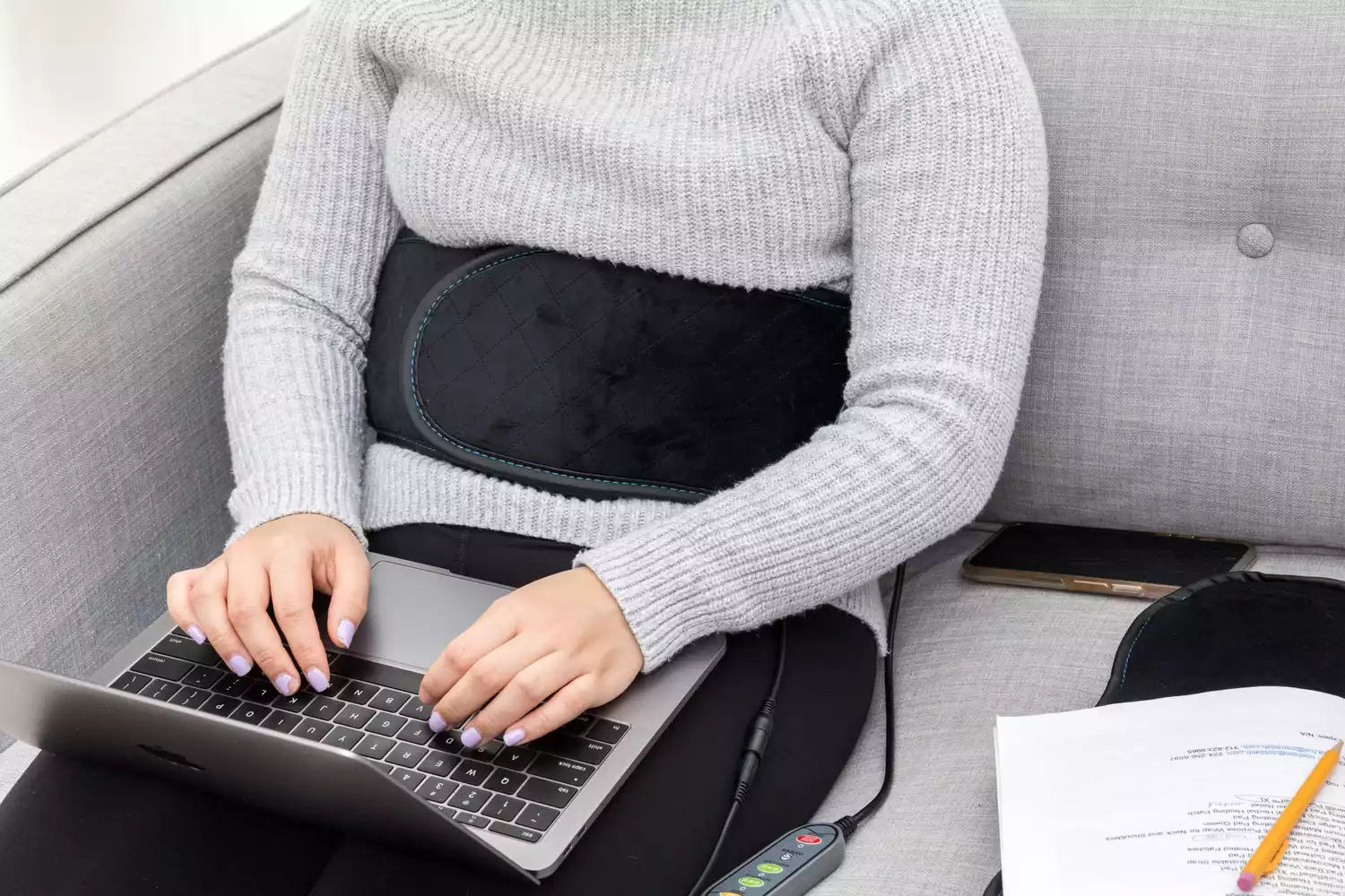 Person working while wearing Comfier Heating Pad with Massager