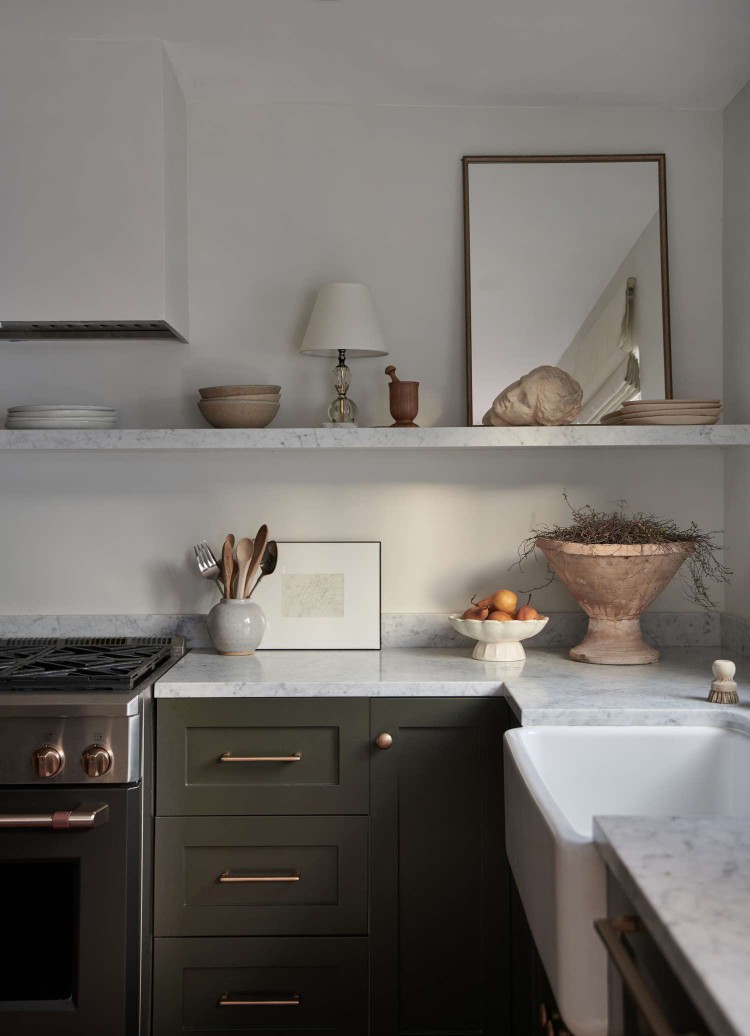 green kitchen with open shelving and leaning art