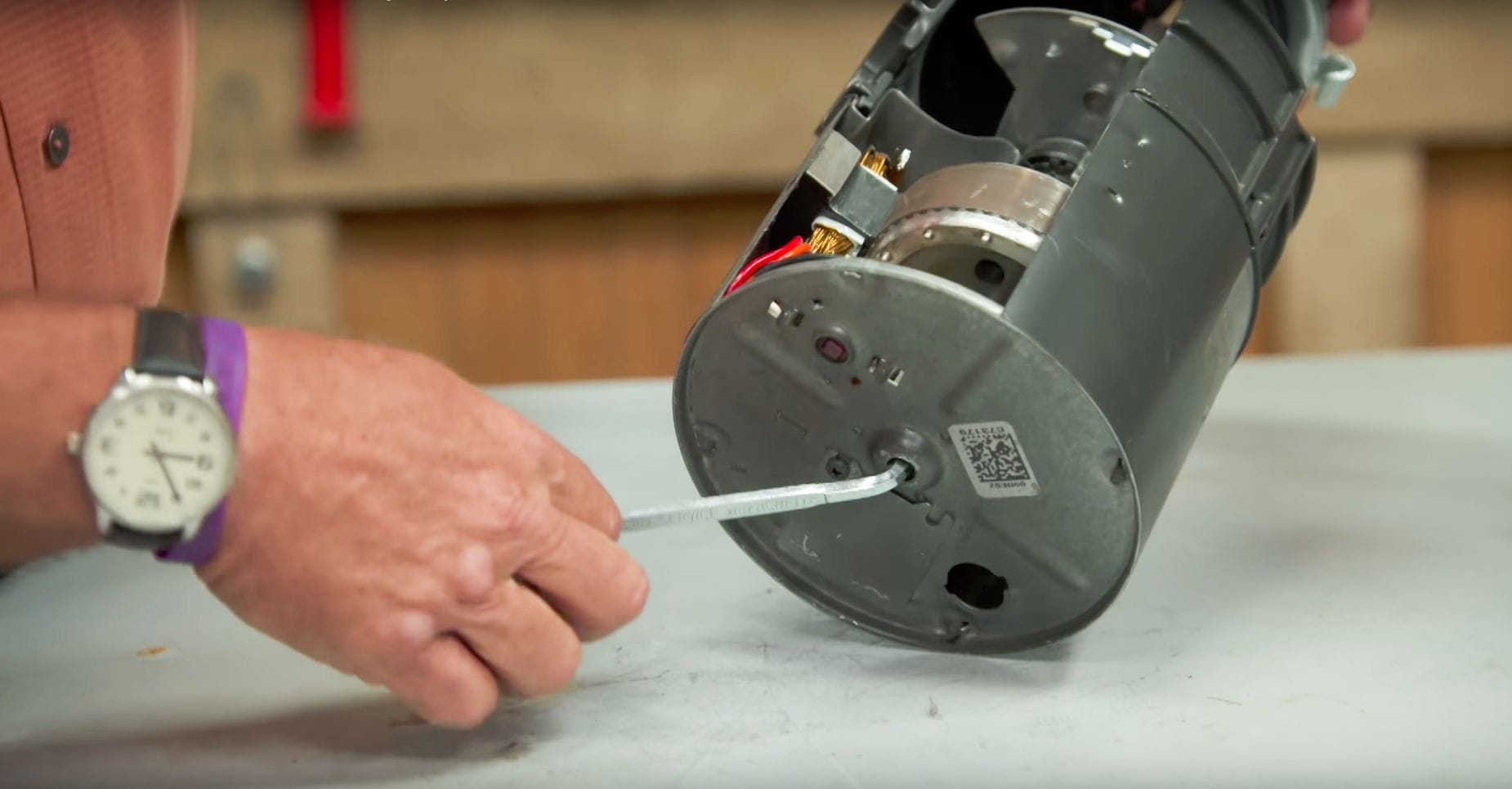 using an Allen wrench to loosen the motor shaft to dislodge the obstruction