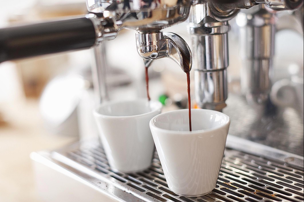 Espresso being dropped into cups