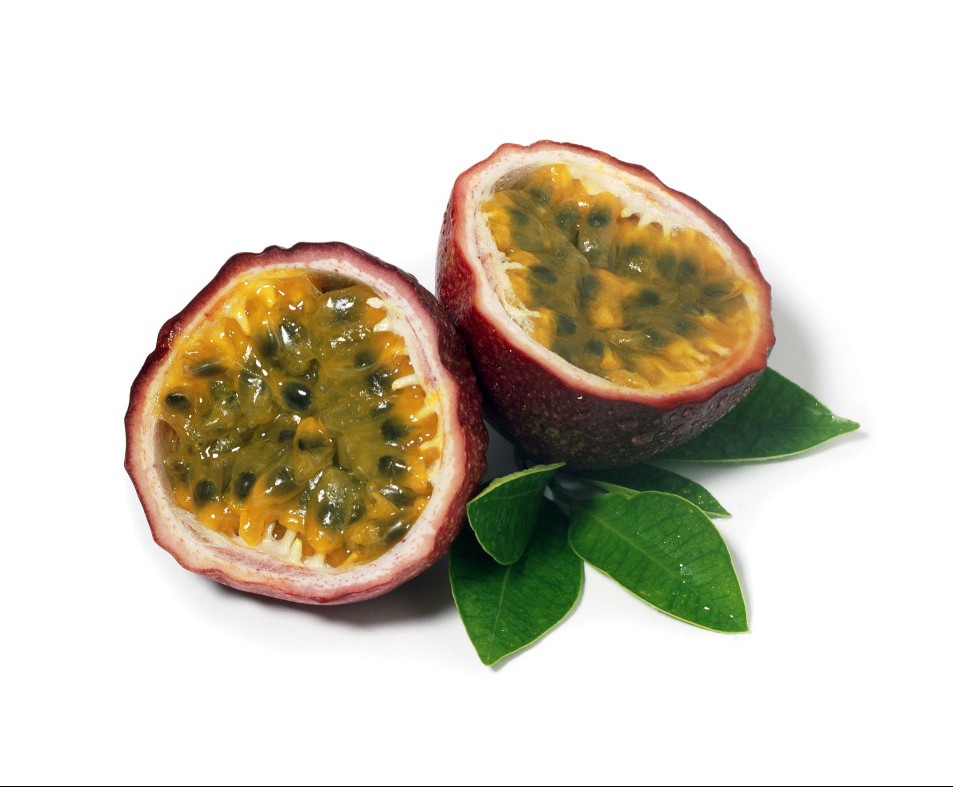 Passion fruit cut in half with leaves.
