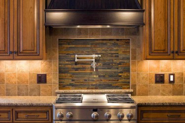 Kitchen with brown wooden cabinets and architectural tile wall behind stovetop