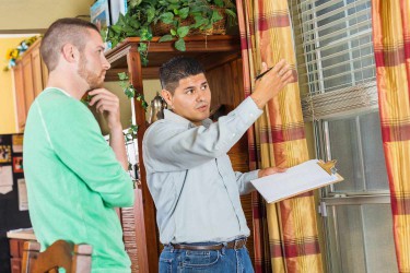 Home inspector explaining damage and repairs to homeowner
