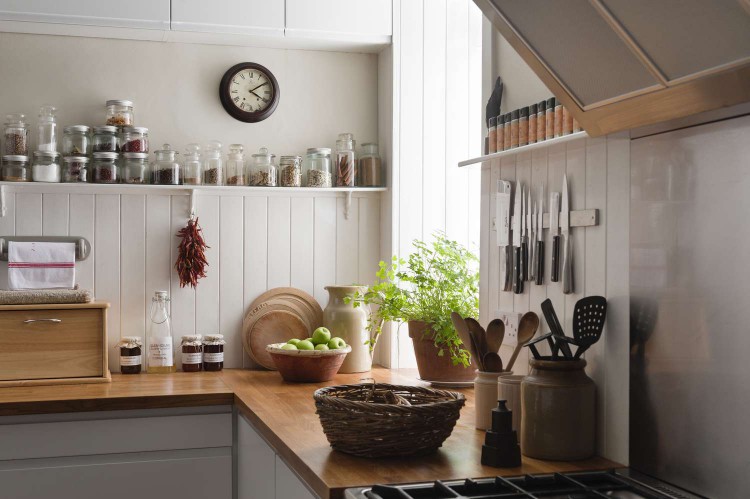 simple kitchen decorated with utensils, baskets, and pottery