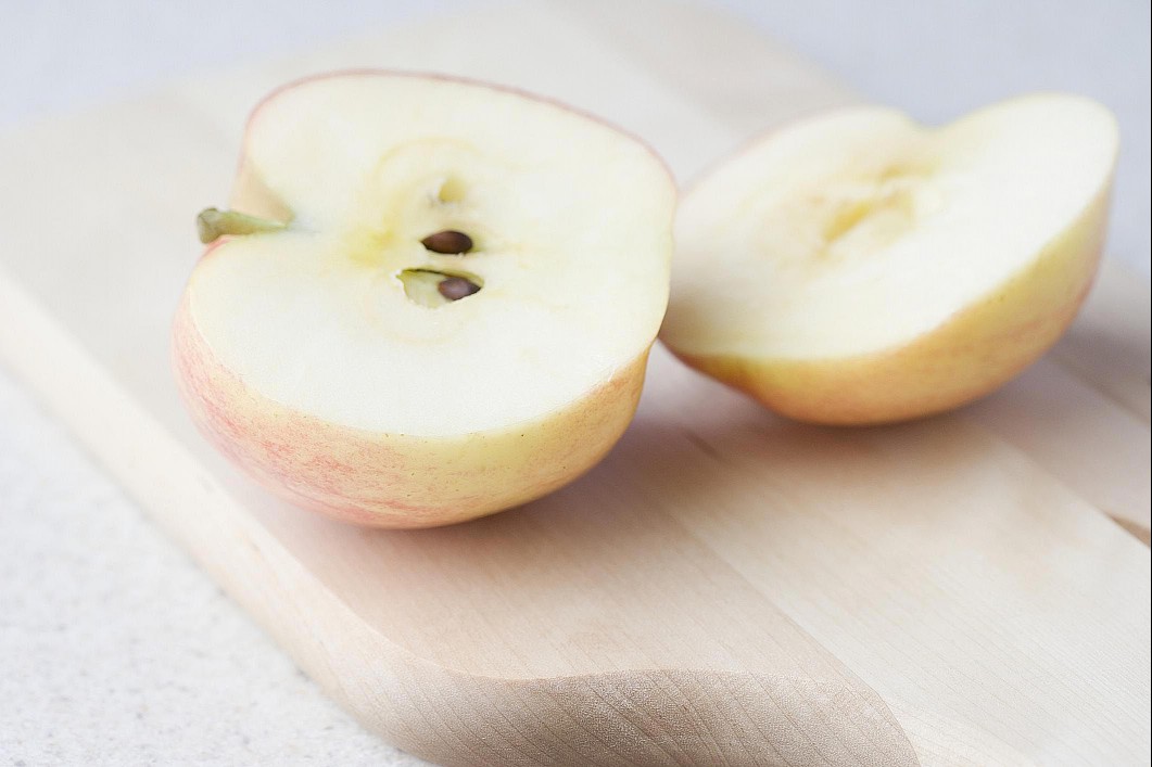 Close up of a cut open apple and its seeds