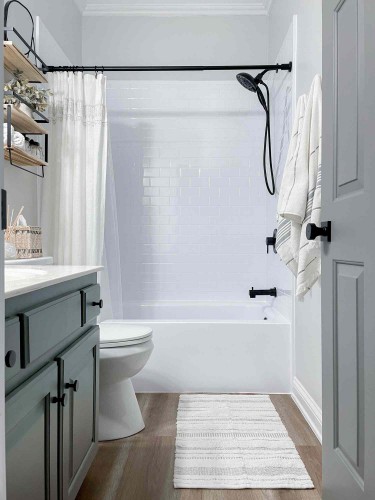 Pretty white and blue bathroom with modern black showerhead.