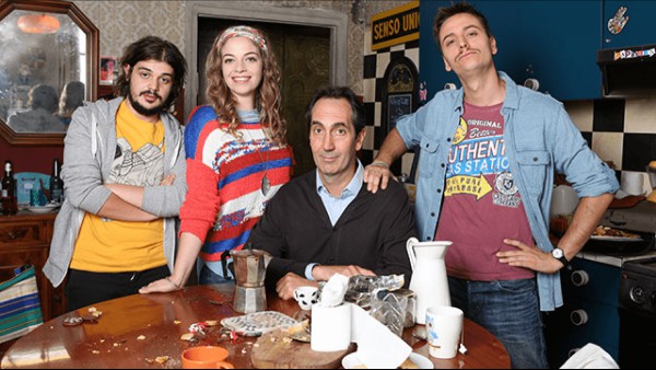 A still from Zio Gianni featuring the key characters in the show around a messy kitchen table.