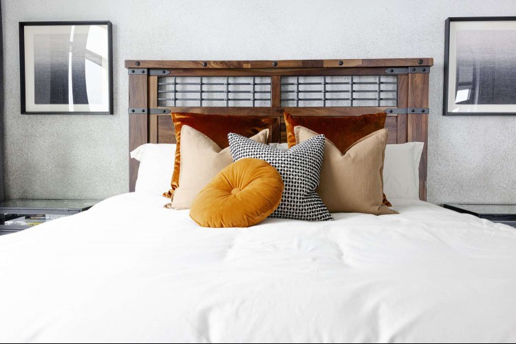 Industrial wood bed with velvet pillows 