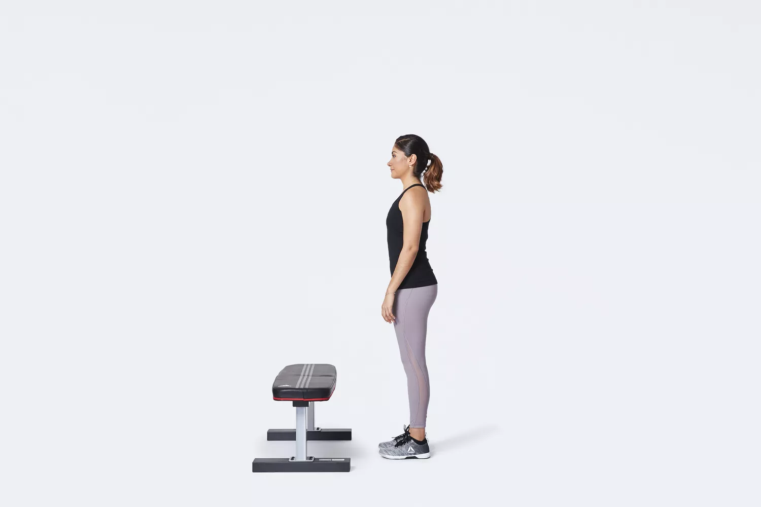 woman standing in front of bench