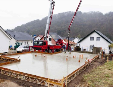 Machines pouring concrete slab