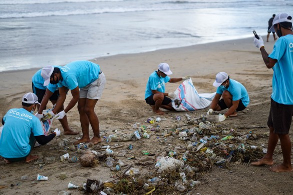 A group of people cleaning up a beach.