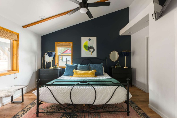 Front view of a bedroom with a dark blue navy accent wall