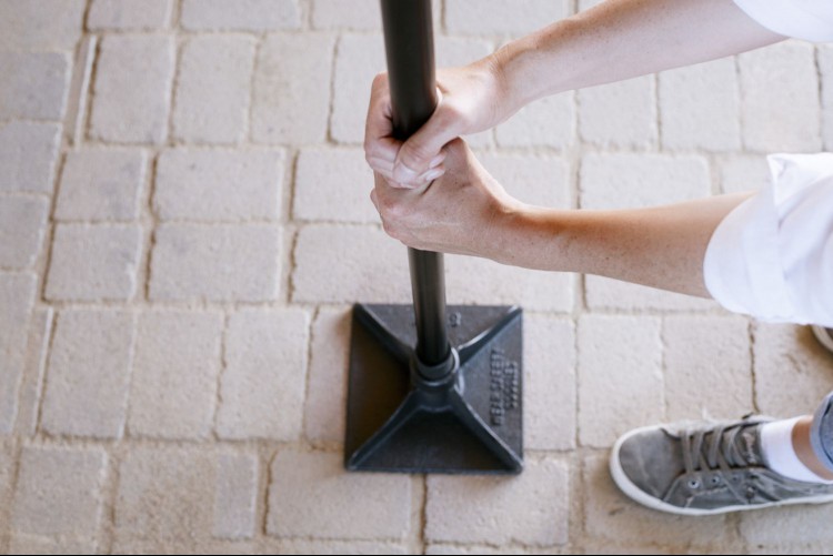 Person tamping down concrete pavers