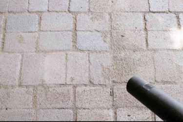 Using a vacuum to clean off concrete pavers