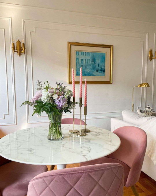 marble table with pink chairs