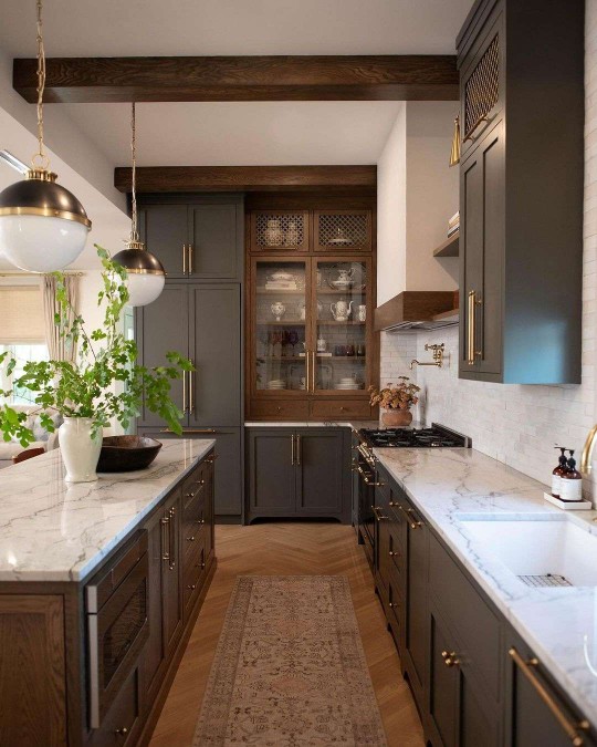 Modern farmhouse kitchen with slate gray green cabinets and wood beam 