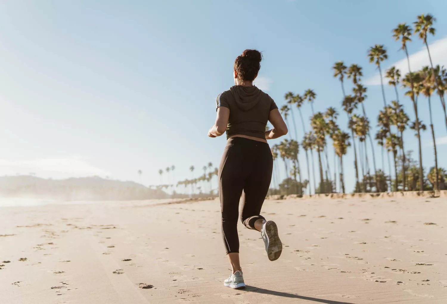 woman jogging on the beach in the morning