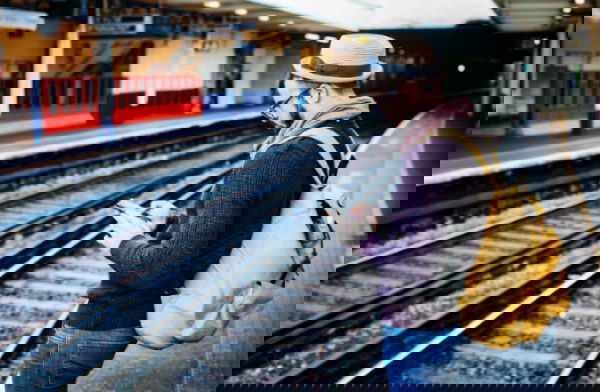 social-media-detox-man-staring-at-phone-by-train