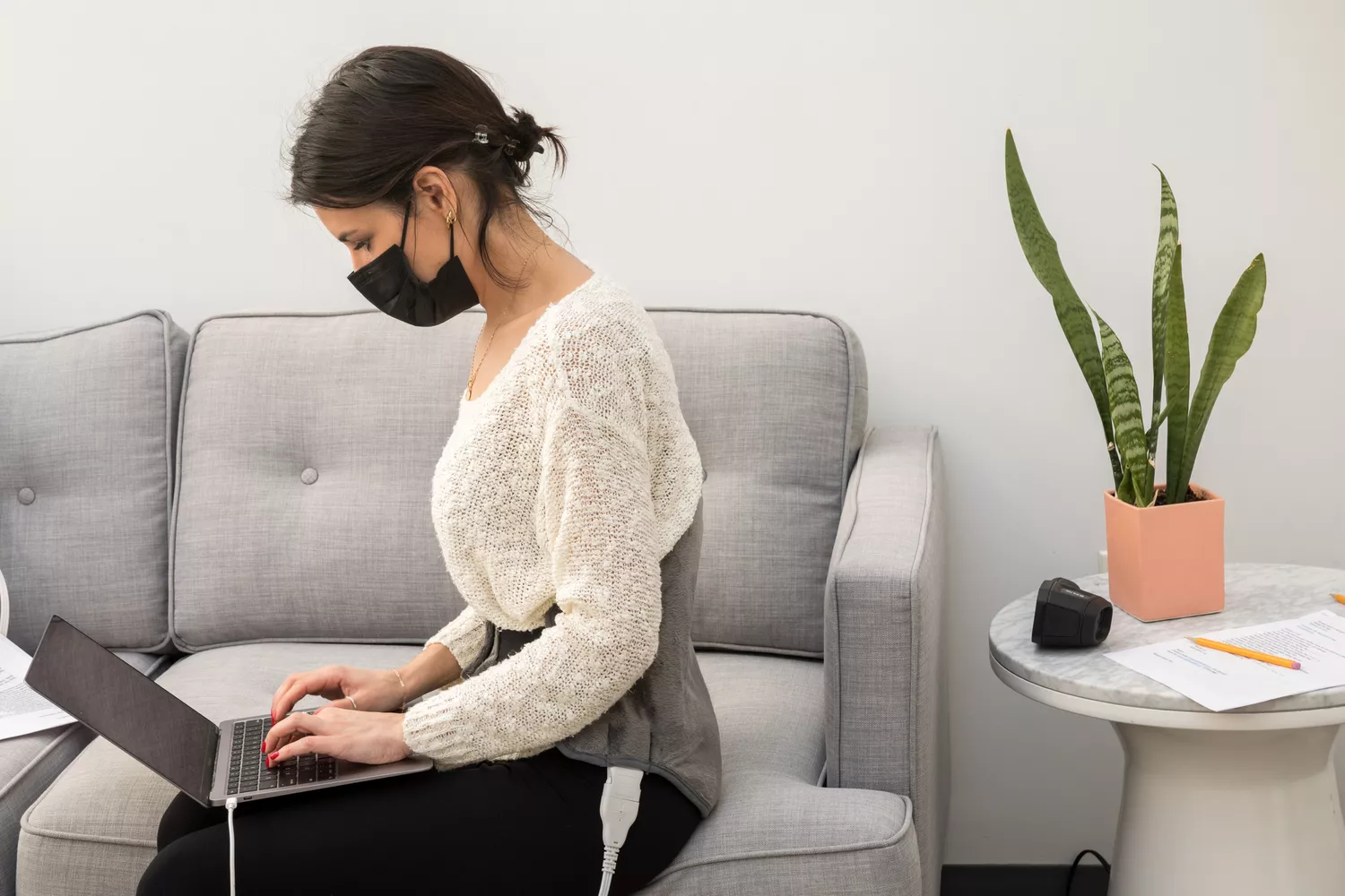 Tester wearing Sunbeam Heating Pad Back Wrap with Adjustable Strap