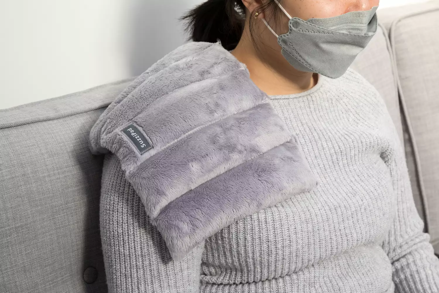 SuzziPad Microwavable Heating Pads are placed on shoulder of women while testing