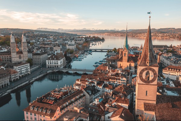 A bird's eye view of a city in Switzerland bisected by a river.