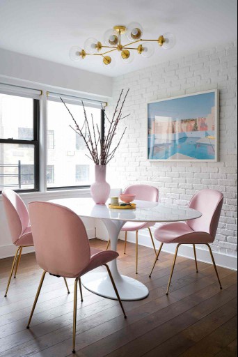 large marble table with pink chairs