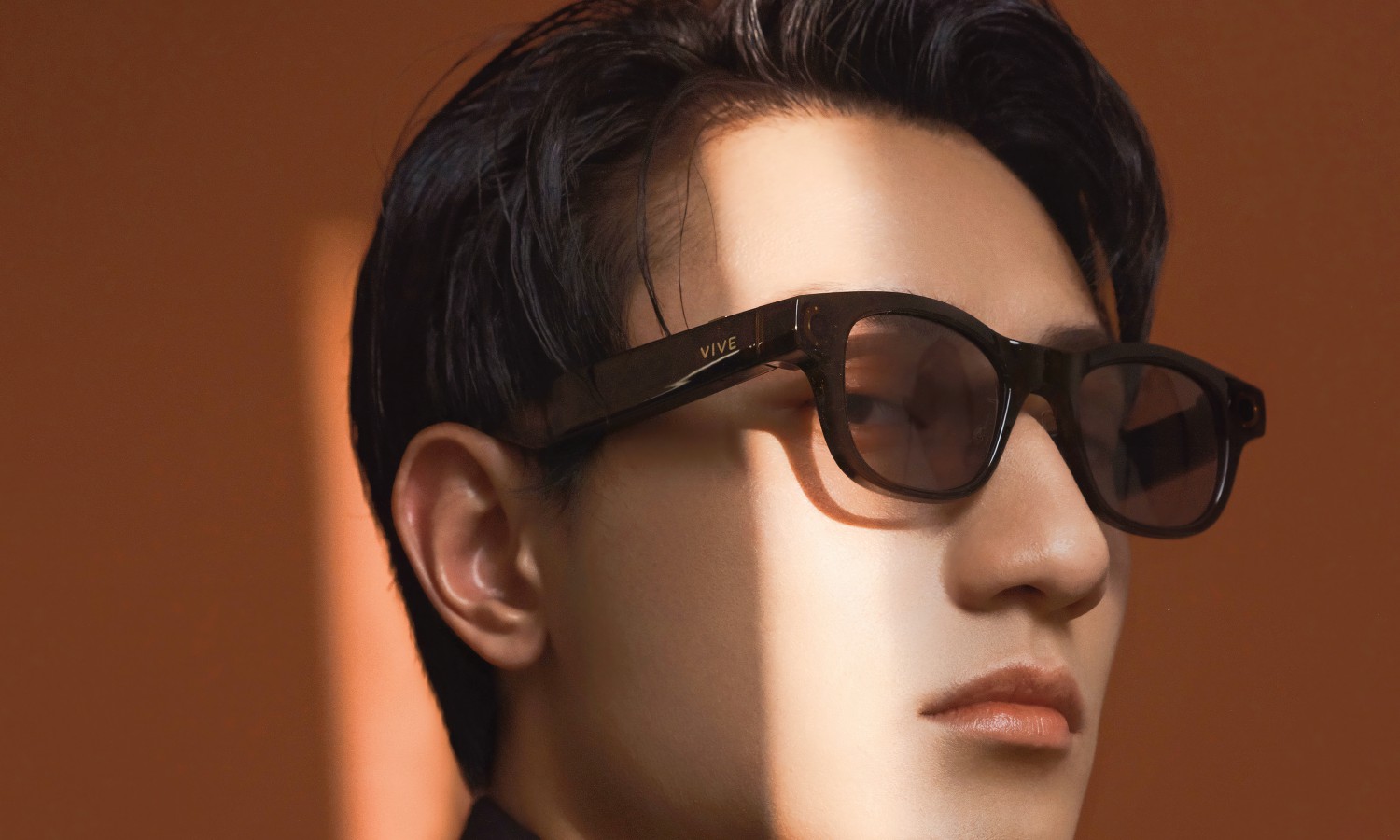 A man wearing the HTC Vive Eagle smart glasses