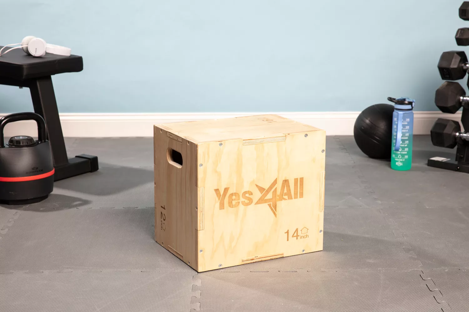 Yes4All 3 in 1 Wooden Plyo Box on gray floor surrounded by fitness equipment