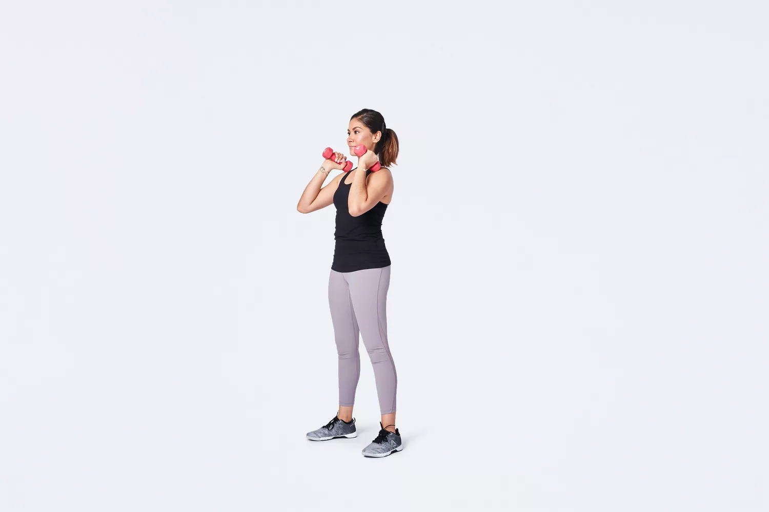 Woman holding dumbbells in hammer curl position