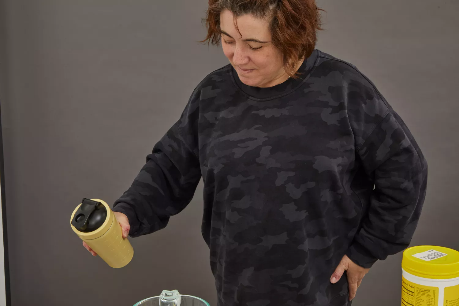 Person holding shaker bottle