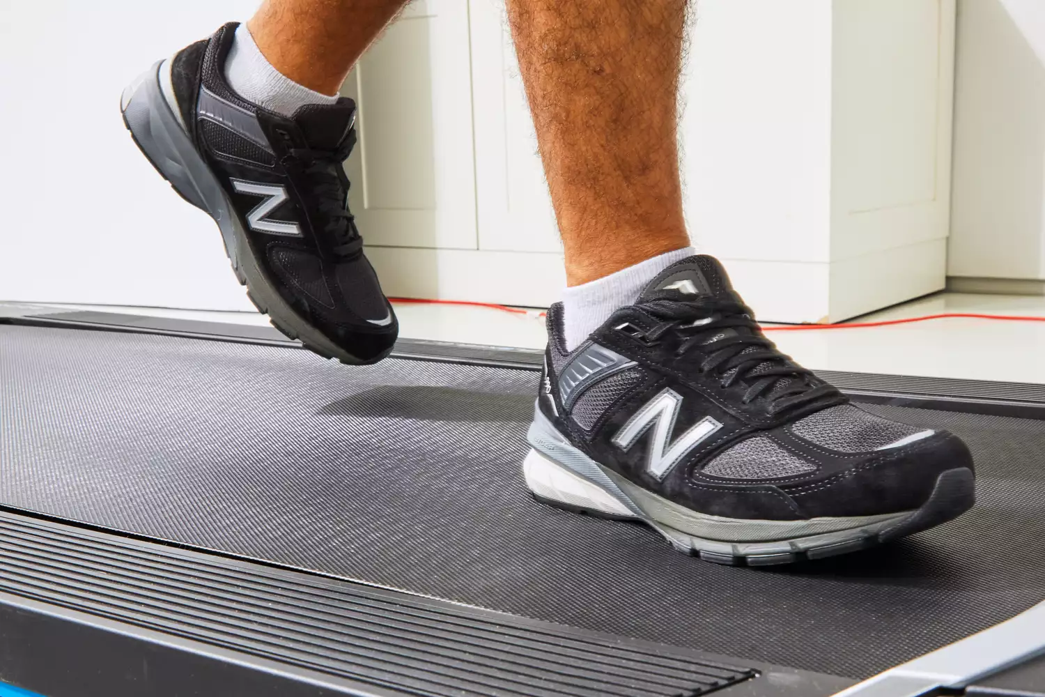 Feet wearing New Balance Men’s 990v6 Running Shoes on treadmill