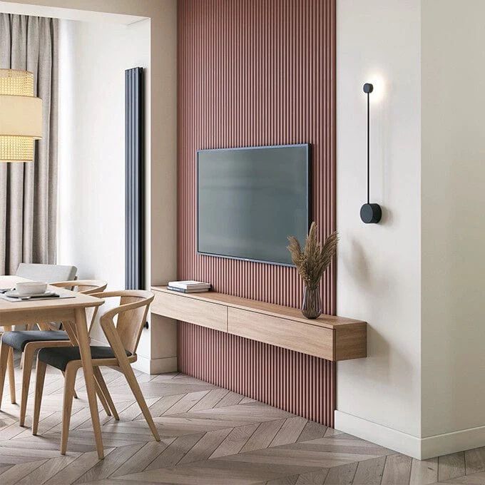 Pink wood paneling behind a TV