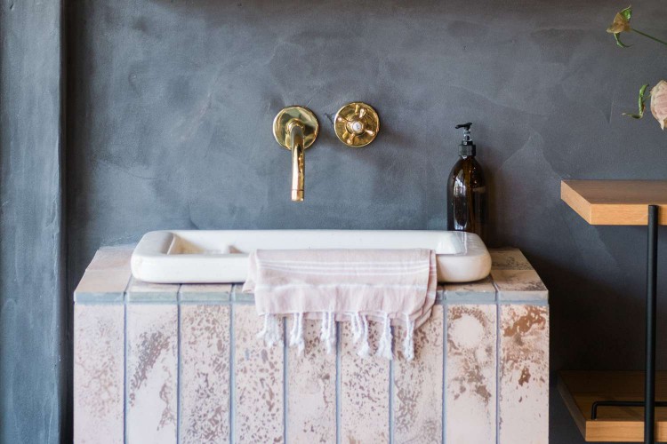 Closeup of wall-mounted faucets in a bathroom