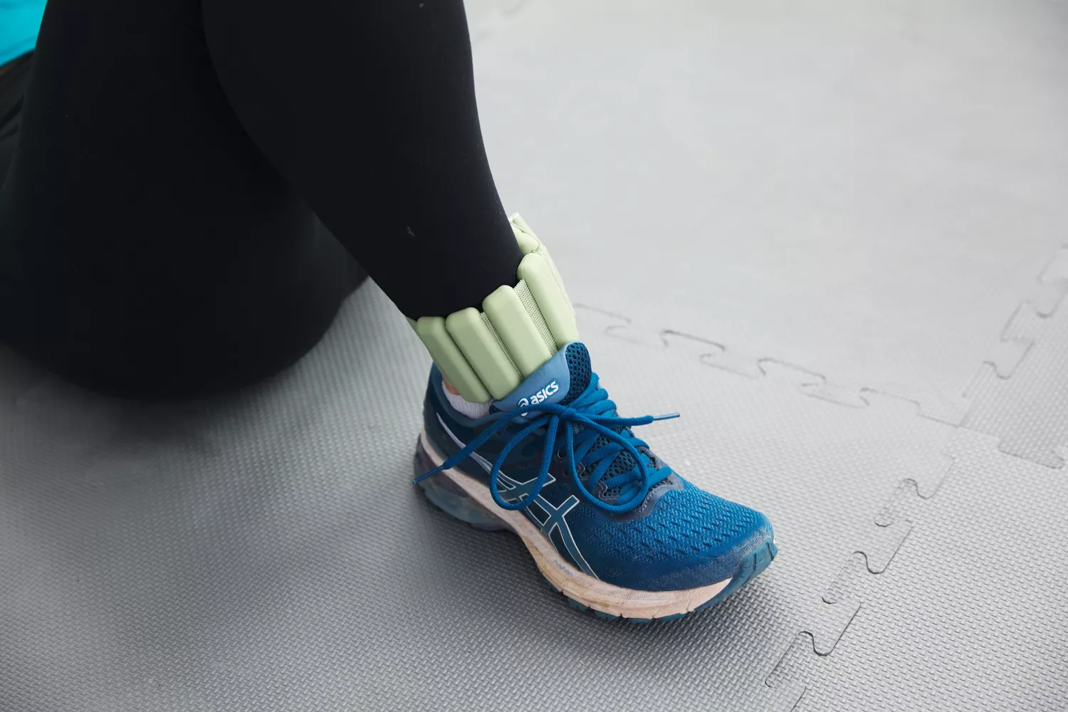 foot planted on ground with Bala Bangle worn on ankle