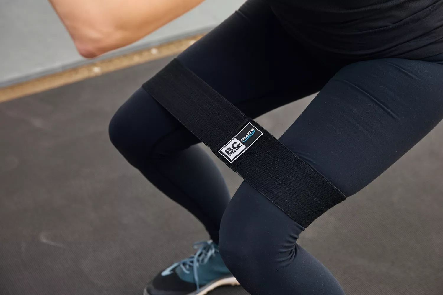 Person using BC Strength Glute Loop Package to do a squat