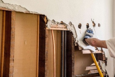 Load-bearing wall being removed for home renovation with exposed structures
