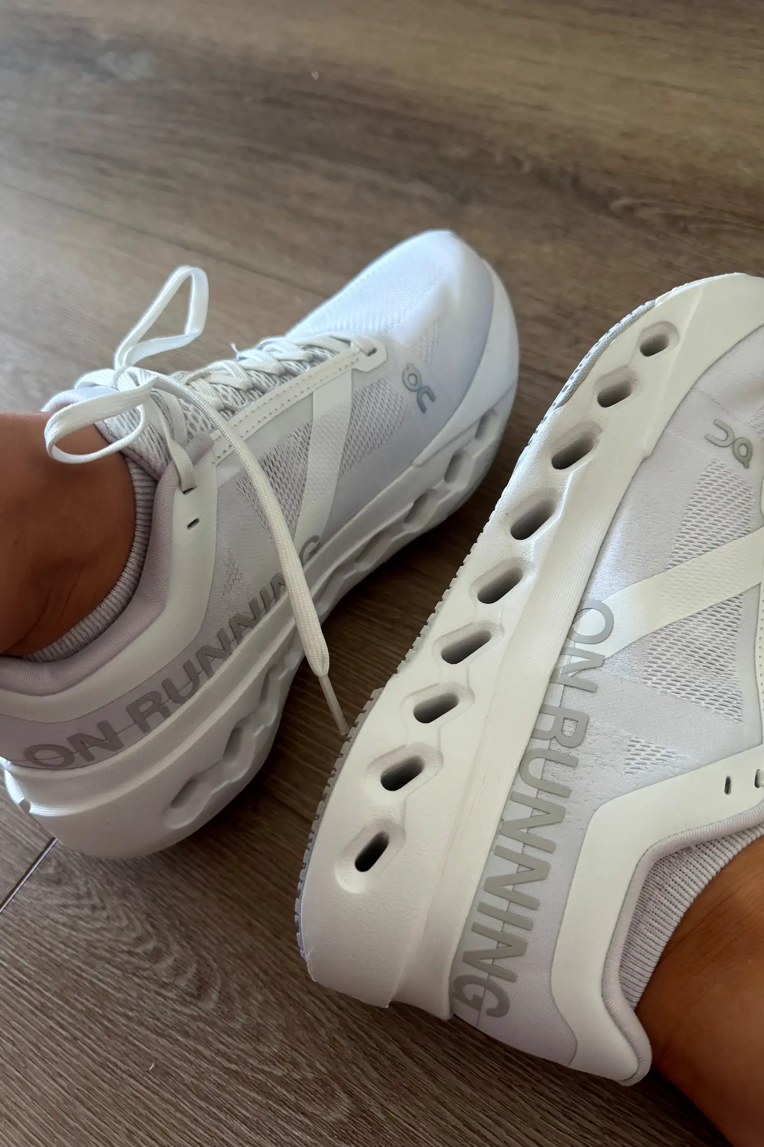 A close-up of the laces and design on the bottom of the On Running Women's Cloudsurfer Next Wide Running Shoes