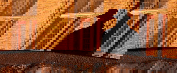 Man On A Bridge In Brugge, Belgium.