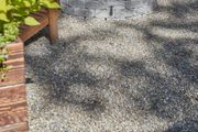 DIY yard with small rock pebbles replacing lawn with drain materials