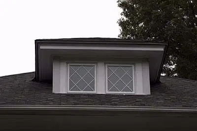 A house with mullioned dormer windows.