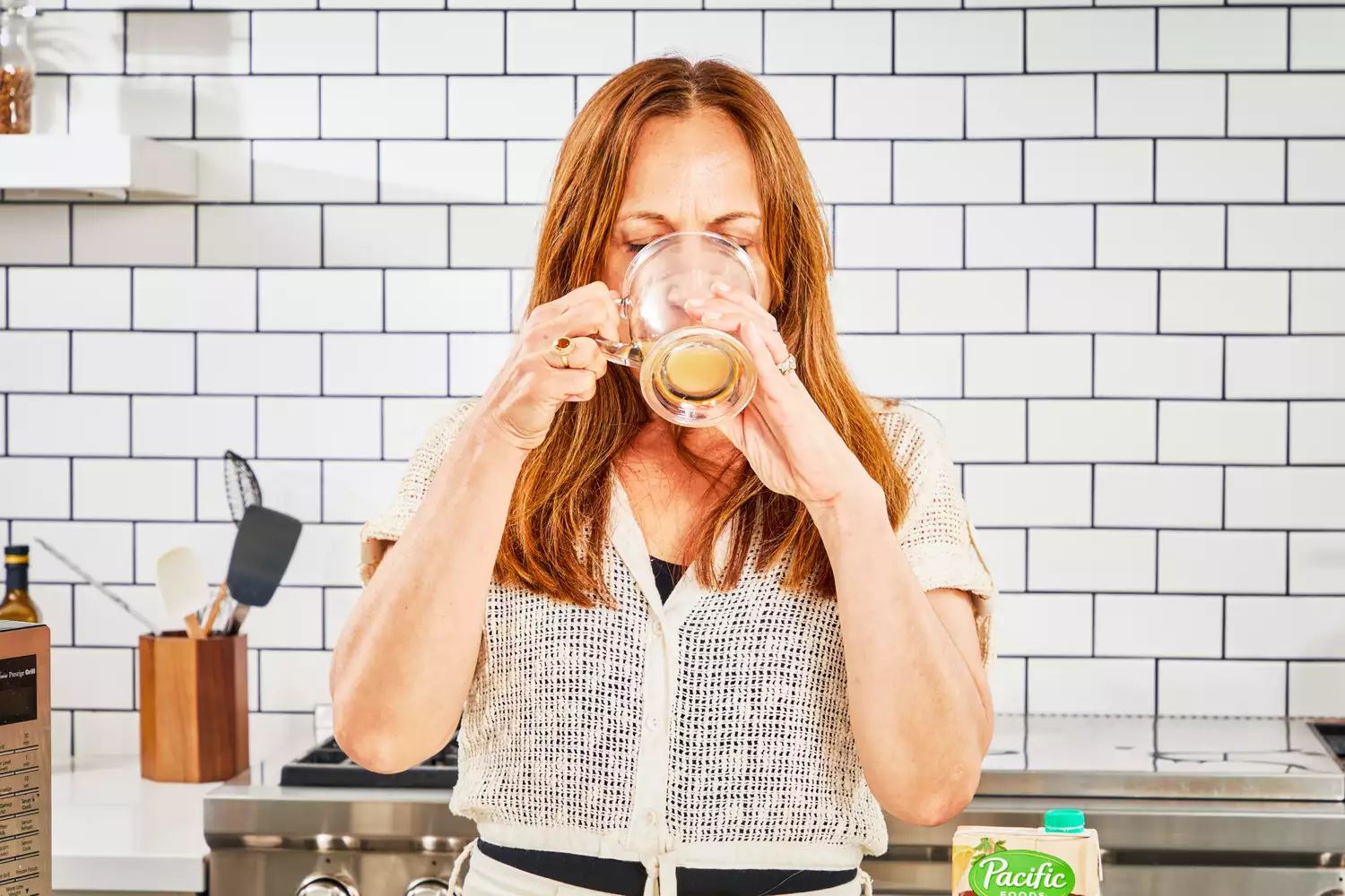 A person drinks a glass of Pacific Foods Chicken Bone Broth