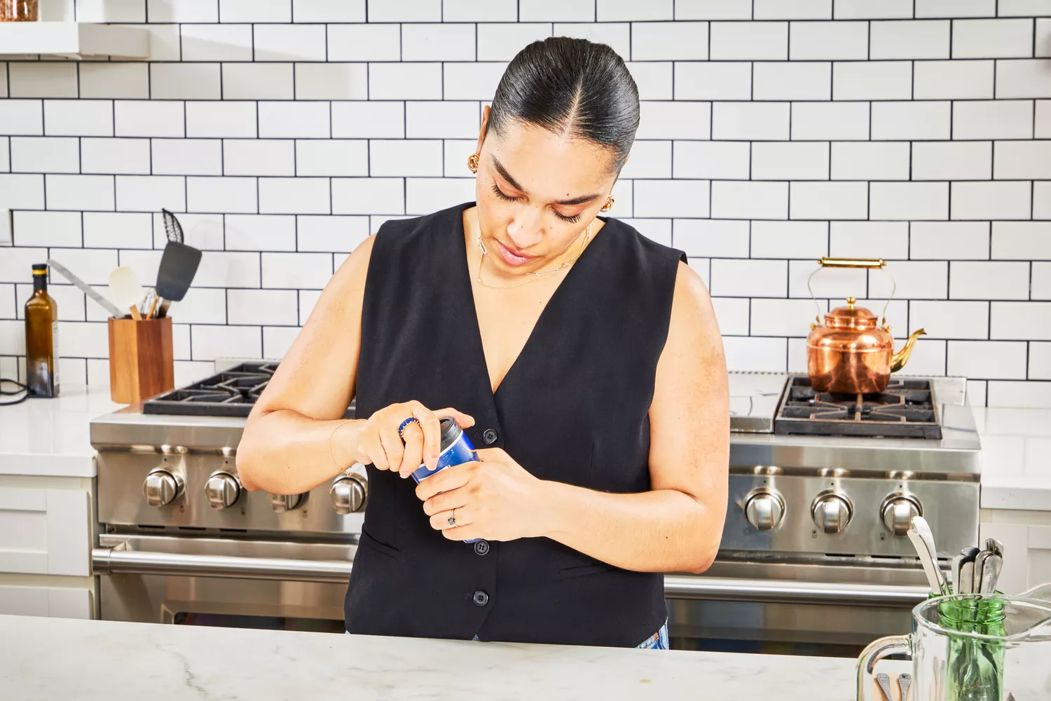A person removes the top from the Swanson Sipping Chicken Bone Broth container