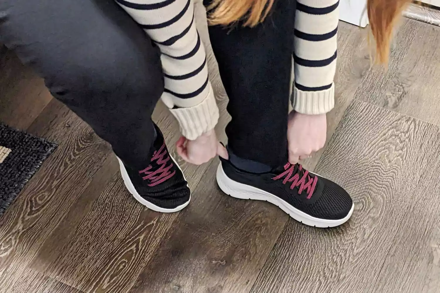 A person putting on Skechers Go Walk Flex Alani Walking Shoes